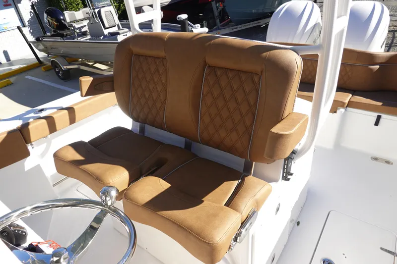 Slide: The Image of 2026 Sea Hunt Ultra 285 Coffin Box boat with luxurious brown seating and steering wheel. - 17