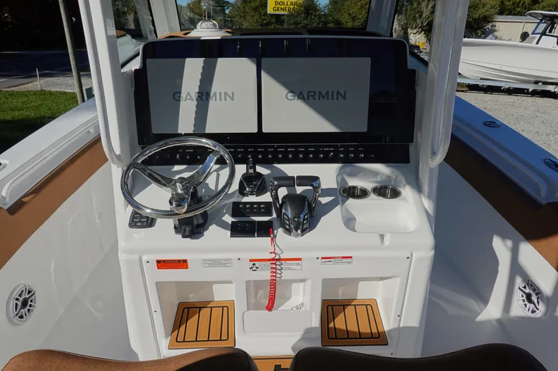 Slide: The Image of 2026 Sea Hunt Ultra 285 Coffin Box boat with luxurious brown seating and steering wheel. - 18