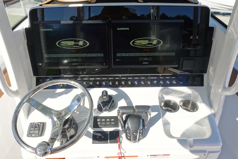 Slide: The Image of 2026 Sea Hunt Ultra 285 Coffin Box helm with dual Garmin displays and controls. - 19