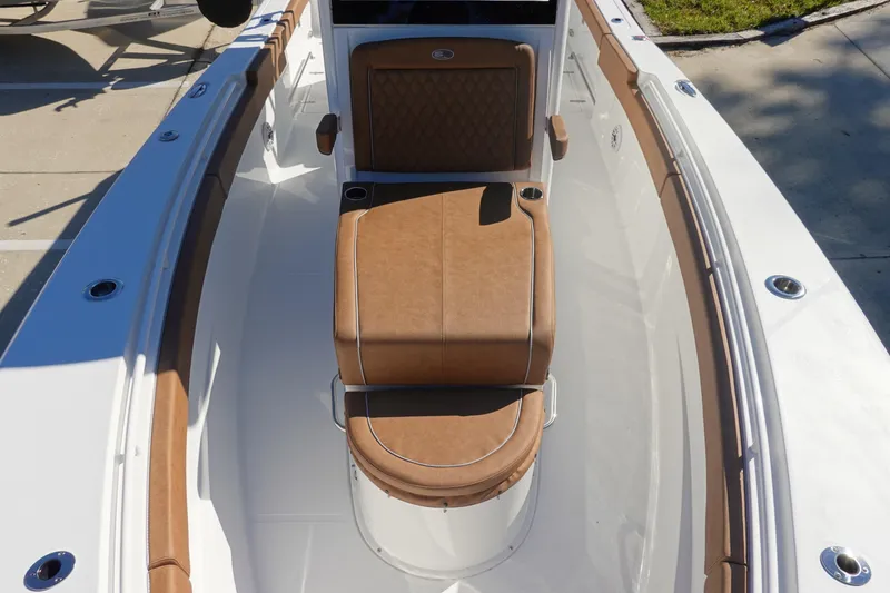 Slide: The Image of 2026 Sea Hunt Ultra 285 Coffin Box with brown cushioned seating and cup holders. - 29