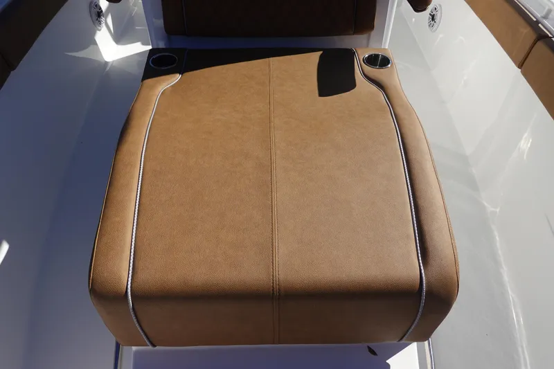 Slide: The Image of 2026 Sea Hunt Ultra 285 Coffin Box boat with brown cushioned seating and sleek white deck. - 30