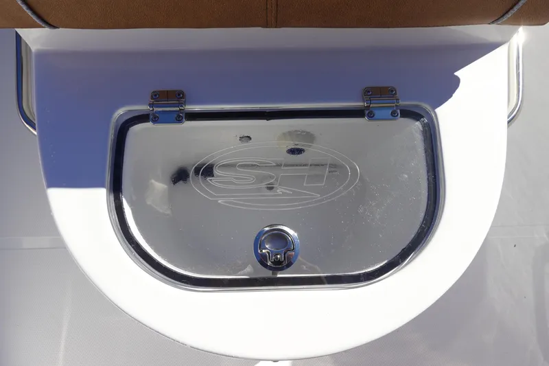 Slide: The Image of 2026 Sea Hunt Ultra 285 Coffin Box boat interior with brown seating and white deck. - 34