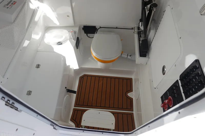 Slide: The Image of 2026 Sea Hunt Ultra 285 Coffin Box anchor compartment, open lid, and deck view. - 37