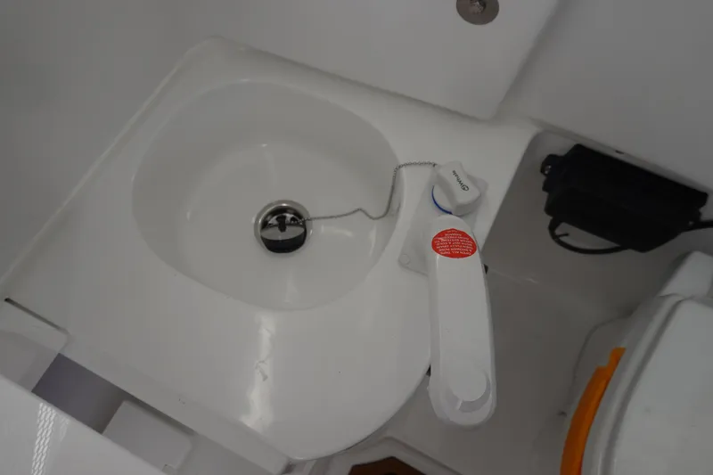 Slide: The Image of 2026 Sea Hunt Ultra 285 Coffin Box interior with cup holders and storage compartment. - 39