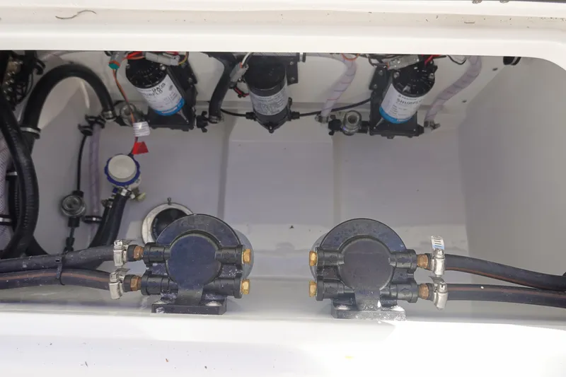 Slide: The Image of 2026 Sea Hunt Ultra 285 Coffin Box interior showing pumps and plumbing components. - 46