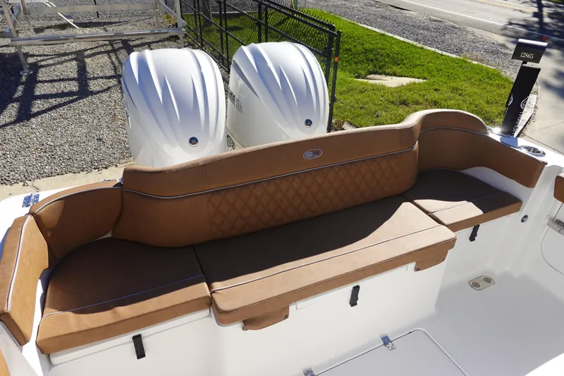 Slide: The Image of 2026 Sea Hunt Ultra 285 Coffin Box boat stern with trim tab and warning label. - 6