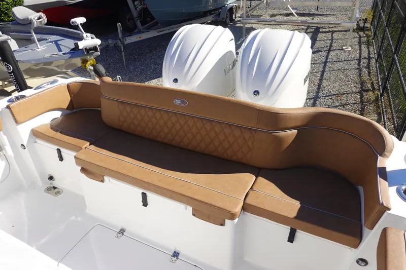 Slide: The Image of 2026 Sea Hunt Ultra 285 Coffin Box boat with tan seating and dual engines. - 7