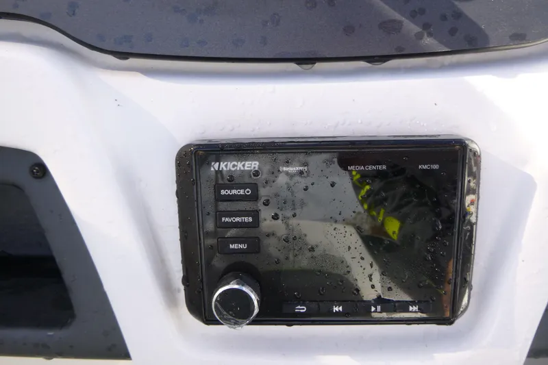 Slide: The Image of Kicker media center on 2021 Tahoe 210 S boat, wet with water droplets. - 13