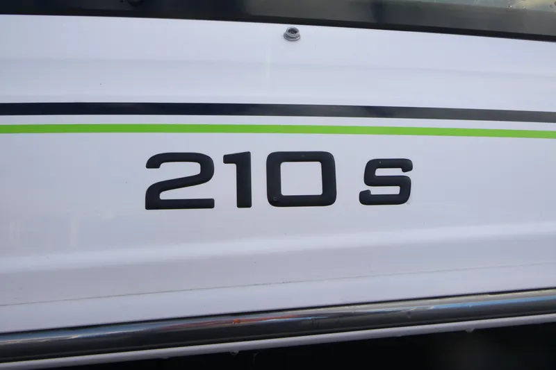 Slide: The Image of 2021 Tahoe 210 S boat model emblem with green stripe detail. - 15