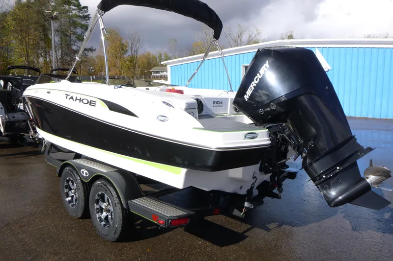 Slide: The Image of 2021 Tahoe 210 S boat with Mercury engine on trailer, parked outdoors. - 3