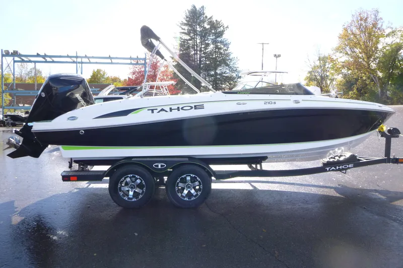 Slide: The Image of 2021 Tahoe 210 S boat on trailer, black and white design, parked outdoors. - 4