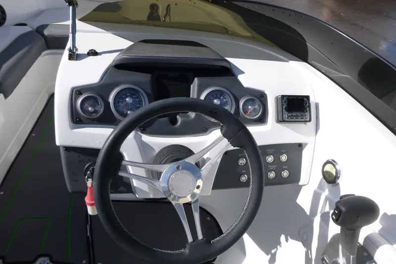 Slide: The Image of 2021 Tahoe 210 S boat dashboard with steering wheel and control panel. - 9