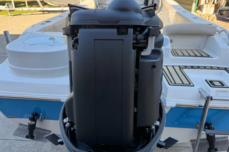 Slide: The Image of 2017 NauticStar 2302 Legacy boat with a powerful outboard motor, rear view. - 10