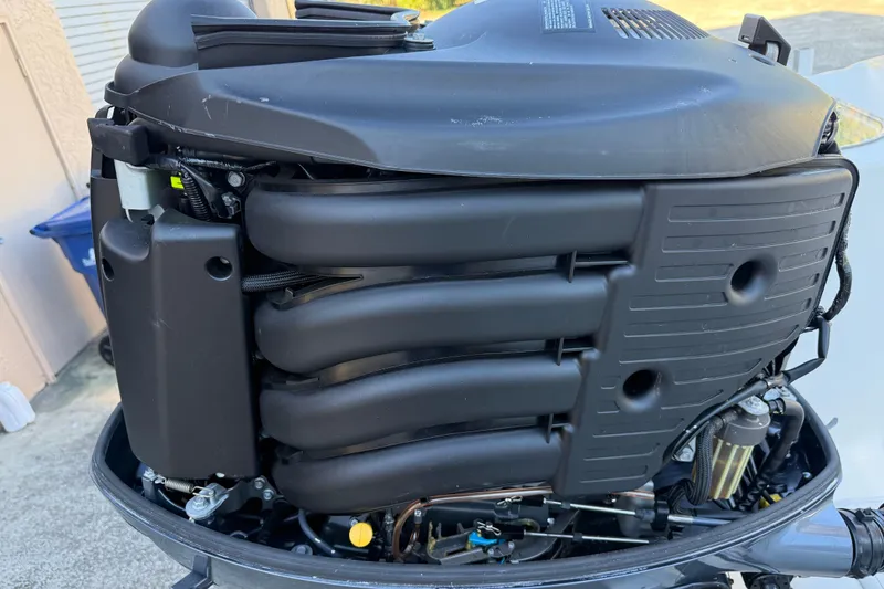 Slide: The Image of Close-up of a 2017 NauticStar 2302 Legacy boat engine, showcasing intricate mechanical details. - 11