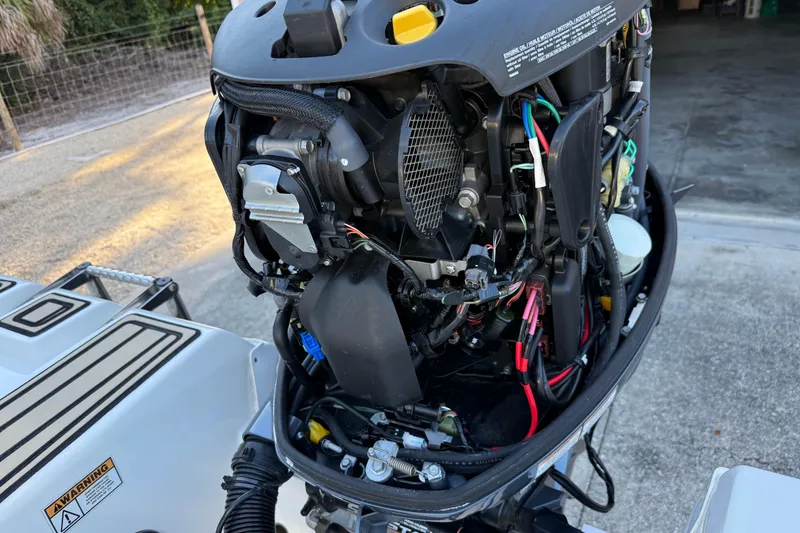 Slide: The Image of Open engine of a 2017 NauticStar 2302 Legacy boat, showing internal components and wiring. - 12