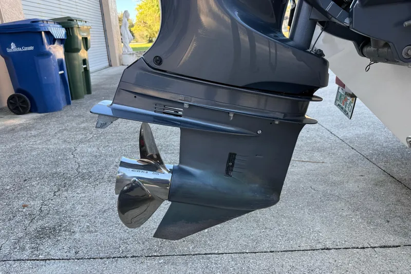 Slide: The Image of Outboard motor of 2017 NauticStar 2302 Legacy boat on driveway. - 13