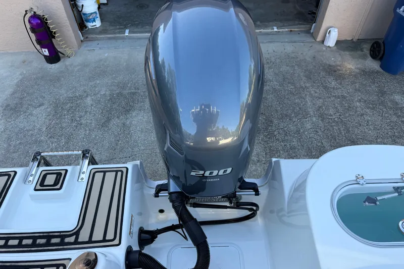 Slide: The Image of 2017 NauticStar 2302 Legacy with Yamaha 200 outboard motor, rear view. - 16