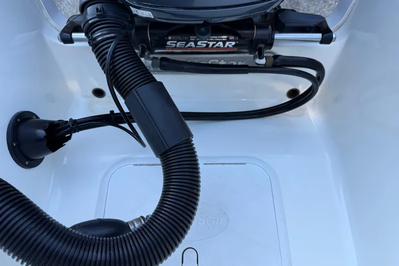 Slide: The Image of Hydraulic steering system on 2017 NauticStar 2302 Legacy boat, featuring SeaStar components. - 17