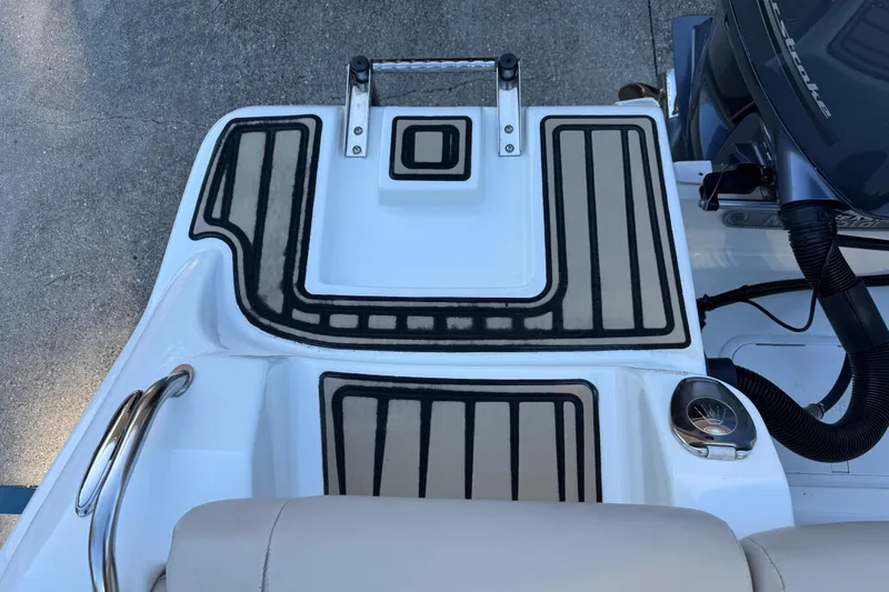 Slide: The Image of 2017 NauticStar 2302 Legacy boat deck with non-slip padding and stainless steel features. - 19