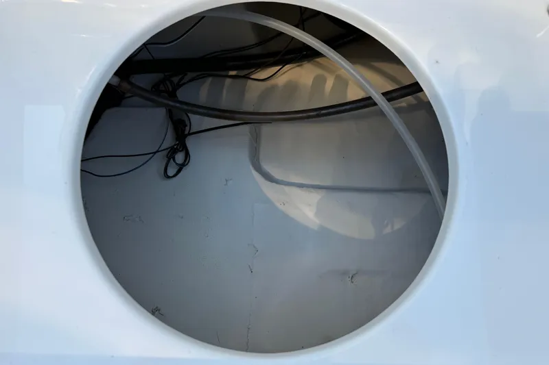 Slide: The Image of Open compartment of 2017 NauticStar 2302 Legacy boat showing internal wiring and tubing. - 27