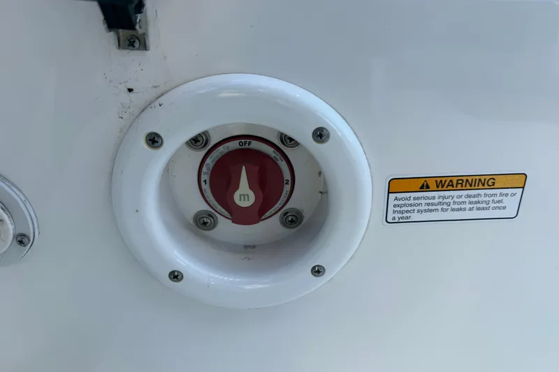 Slide: The Image of 2017 NauticStar 2302 Legacy boat fuel selector switch with safety warning label. - 28