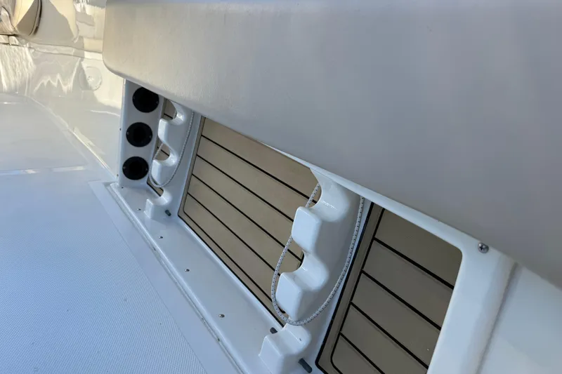 Slide: The Image of 2017 NauticStar 2302 Legacy boat interior with rod holders and storage compartments. - 30