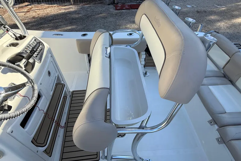 Slide: The Image of 2017 NauticStar 2302 Legacy boat interior with steering wheel and seating area. - 32