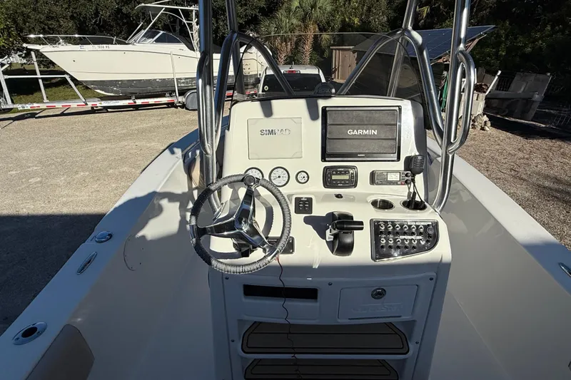 Slide: The Image of 2017 NauticStar 2302 Legacy boat console with Garmin navigation system and steering wheel. - 36