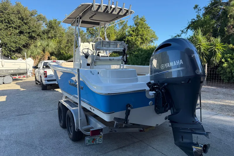 Slide: The Image of 2017 NauticStar 2302 Legacy boat with Yamaha engine on trailer, parked outdoors. - 4