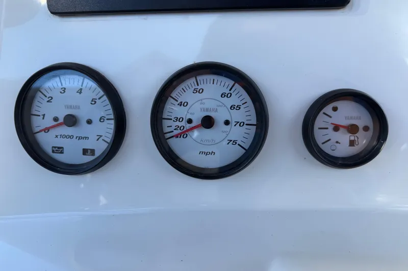 Slide: The Image of Yamaha gauges on 2017 NauticStar 2302 Legacy boat dashboard, showing RPM, speed, and fuel levels. - 40