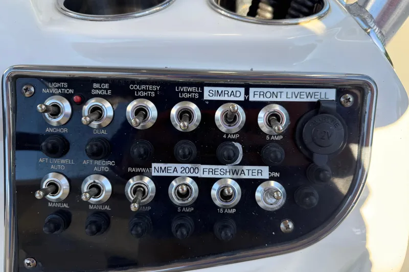 Slide: The Image of Control panel of a 2017 NauticStar 2302 Legacy boat with labeled switches. - 43