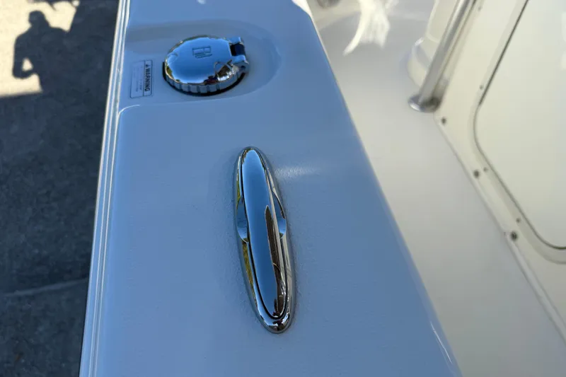 Slide: The Image of 2017 NauticStar 2302 Legacy boat deck with chrome cleat and fuel cap. - 46