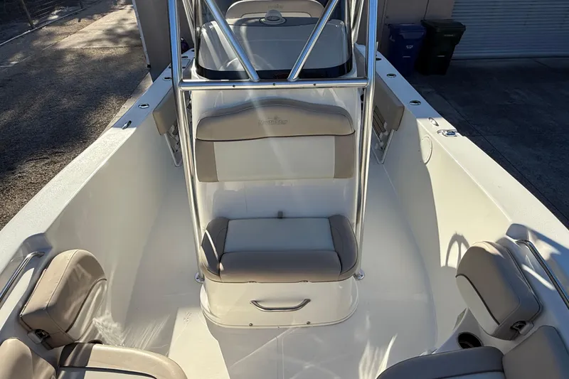 Slide: The Image of 2017 NauticStar 2302 Legacy boat interior with cushioned seating and stainless steel railings. - 51