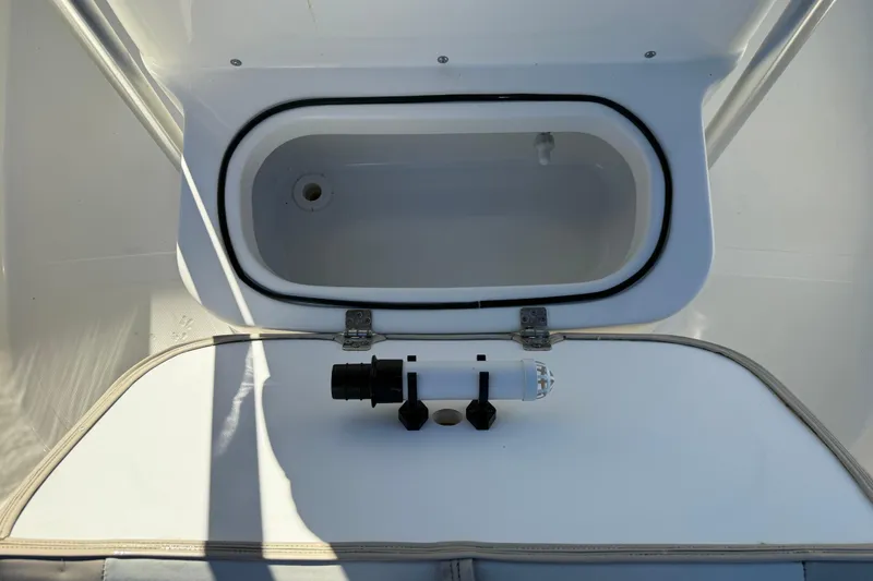 Slide: The Image of Livewell compartment on a 2017 NauticStar 2302 Legacy boat, featuring a clean, white interior. - 52