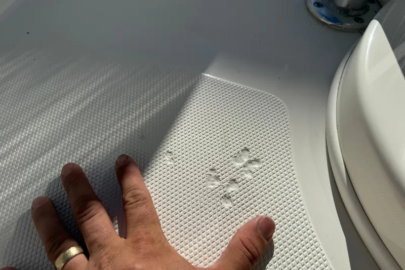 Slide: The Image of Hand inspecting textured surface on 2017 NauticStar 2302 Legacy boat deck. - 53