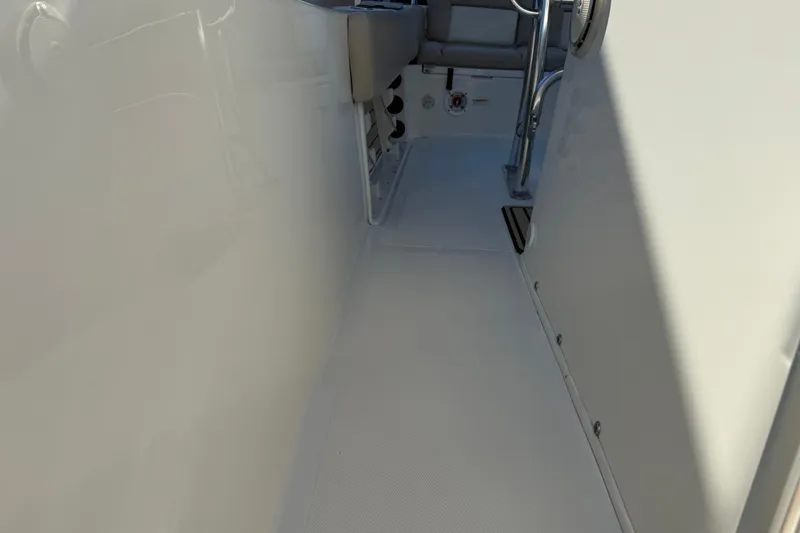 Slide: The Image of 2017 NauticStar 2302 Legacy boat interior walkway with seating and railing. - 55