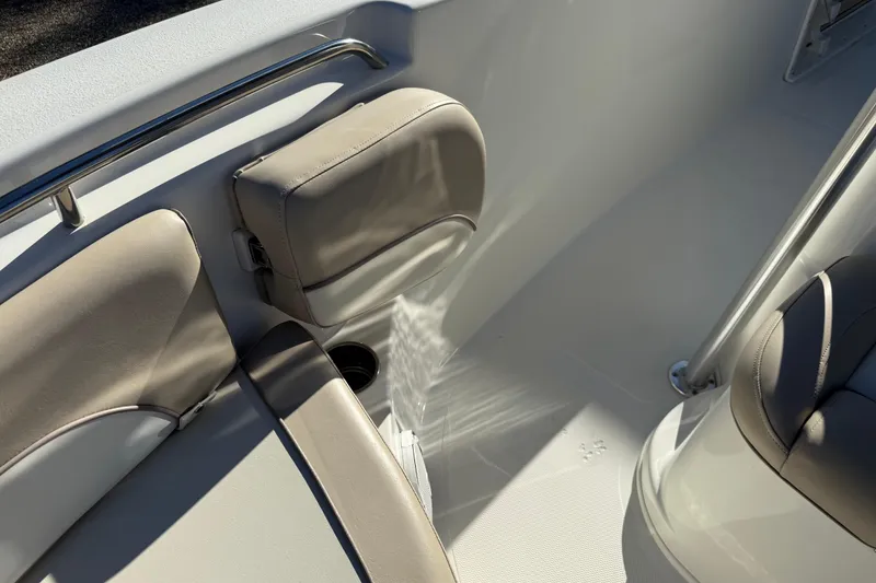 Slide: The Image of Interior seating of 2017 NauticStar 2302 Legacy boat, featuring beige cushions and stainless steel rail. - 59
