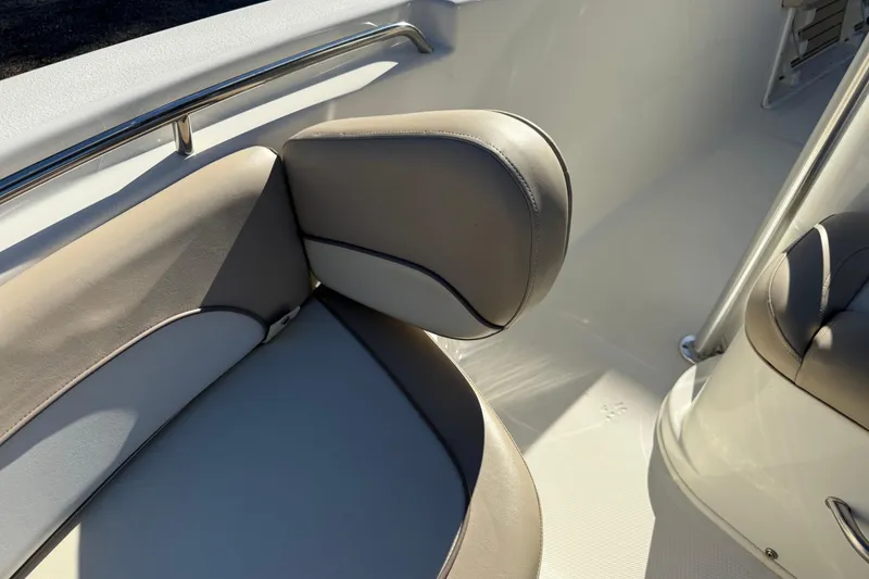 Slide: The Image of 2017 NauticStar 2302 Legacy boat interior with cushioned seating and stainless steel railing. - 60