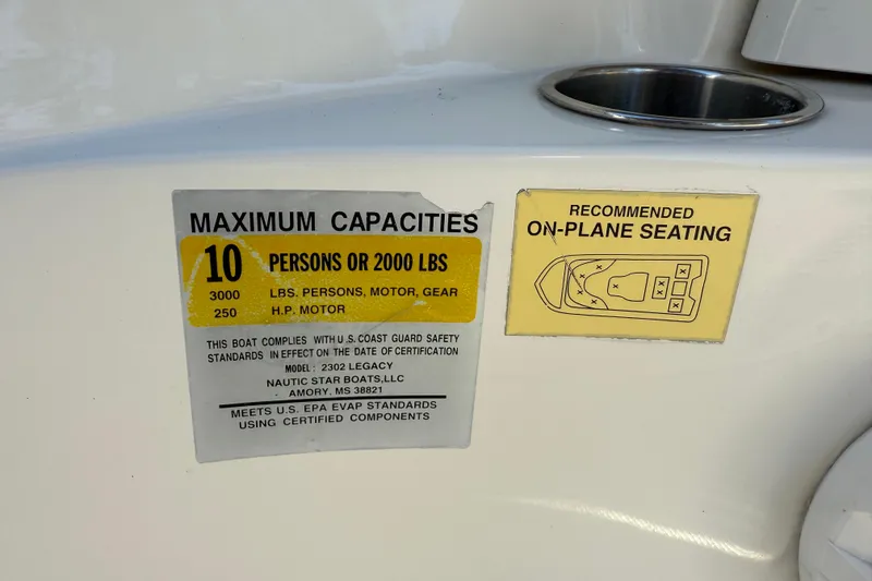Slide: The Image of Capacity and seating labels on 2017 NauticStar 2302 Legacy boat. - 62