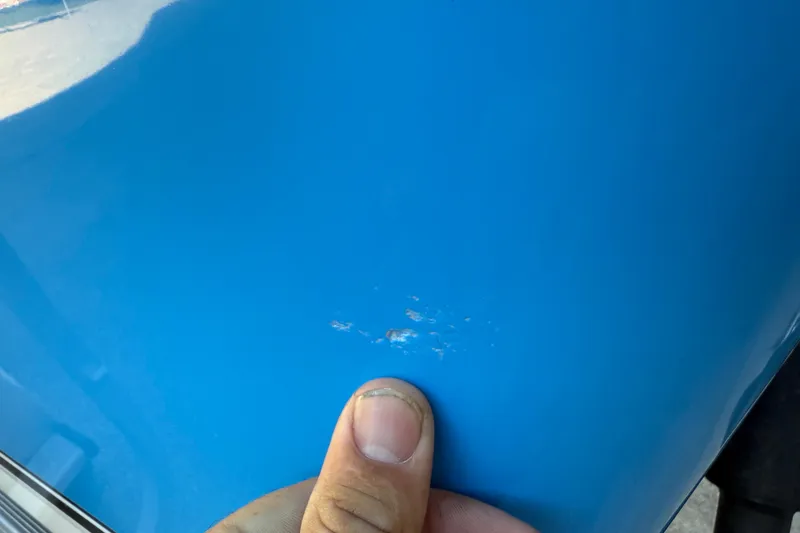 Slide: The Image of Close-up of a scratch on a 2017 NauticStar 2302 Legacy boat hull. - 63