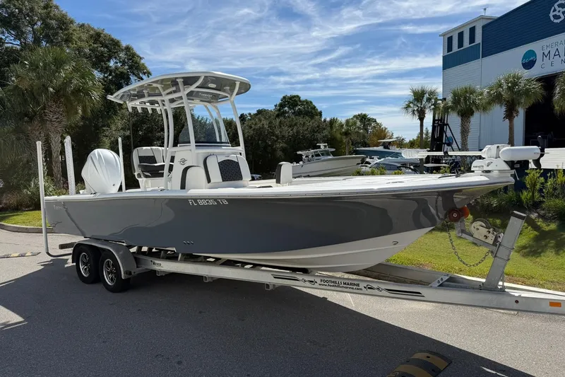 Slide: The Image of 2021 Tidewater 2500 Carolina Bay boat on trailer, parked near marine center. - 0