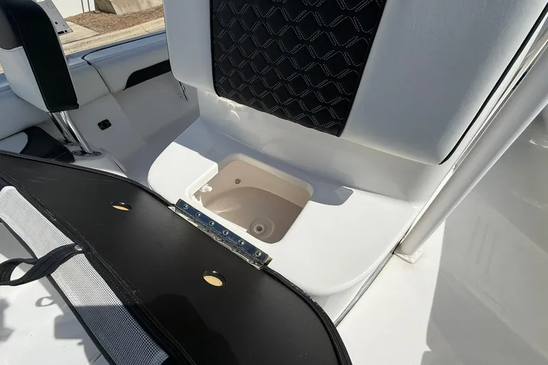 Slide: The Image of 2021 Tidewater 2500 Carolina Bay boat interior with open storage compartment. - 12