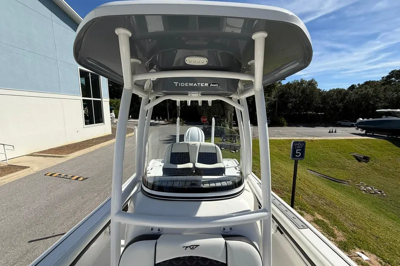 Slide: The Image of 2021 Tidewater 2500 Carolina Bay boat with T-top, parked near a building. - 14