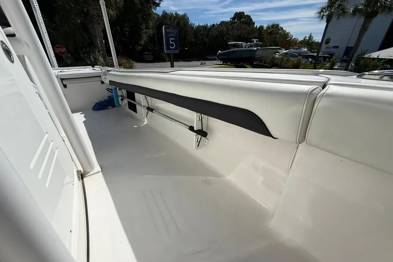 Slide: The Image of 2021 Tidewater 2500 Carolina Bay boat interior with white seating and storage. - 16