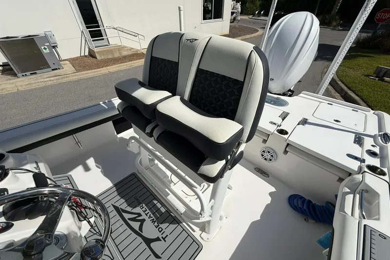 Slide: The Image of 2021 Tidewater 2500 Carolina Bay boat interior with dual seats and steering console. - 18