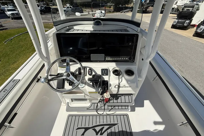 Slide: The Image of 2021 Tidewater 2500 Carolina Bay boat console with steering wheel and controls. - 19