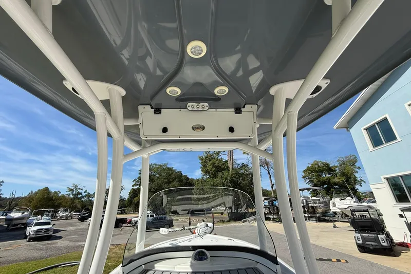 Slide: The Image of 2021 Tidewater 2500 Carolina Bay boat with T-top and console, parked outdoors. - 20
