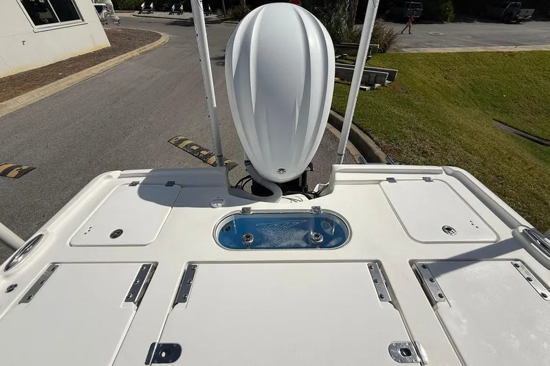 Slide: The Image of 2021 Tidewater 2500 Carolina Bay boat with outboard motor and storage compartments. - 22