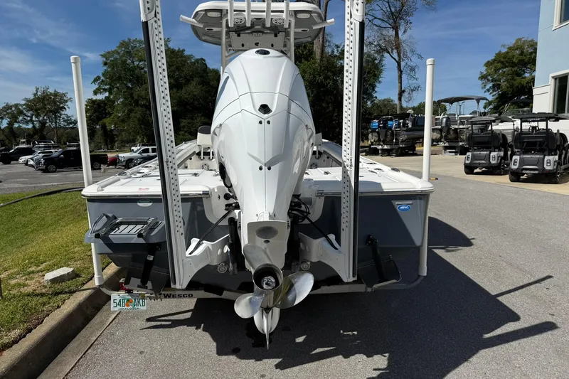Slide: The Image of 2021 Tidewater 2500 Carolina Bay boat rear view with outboard motor in parking lot. - 3