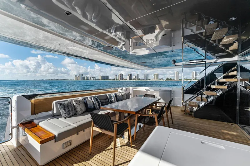 Slide: The Image of Luxurious 2024 Custom Line 106 yacht deck with seating, dining area, and ocean view. - 31